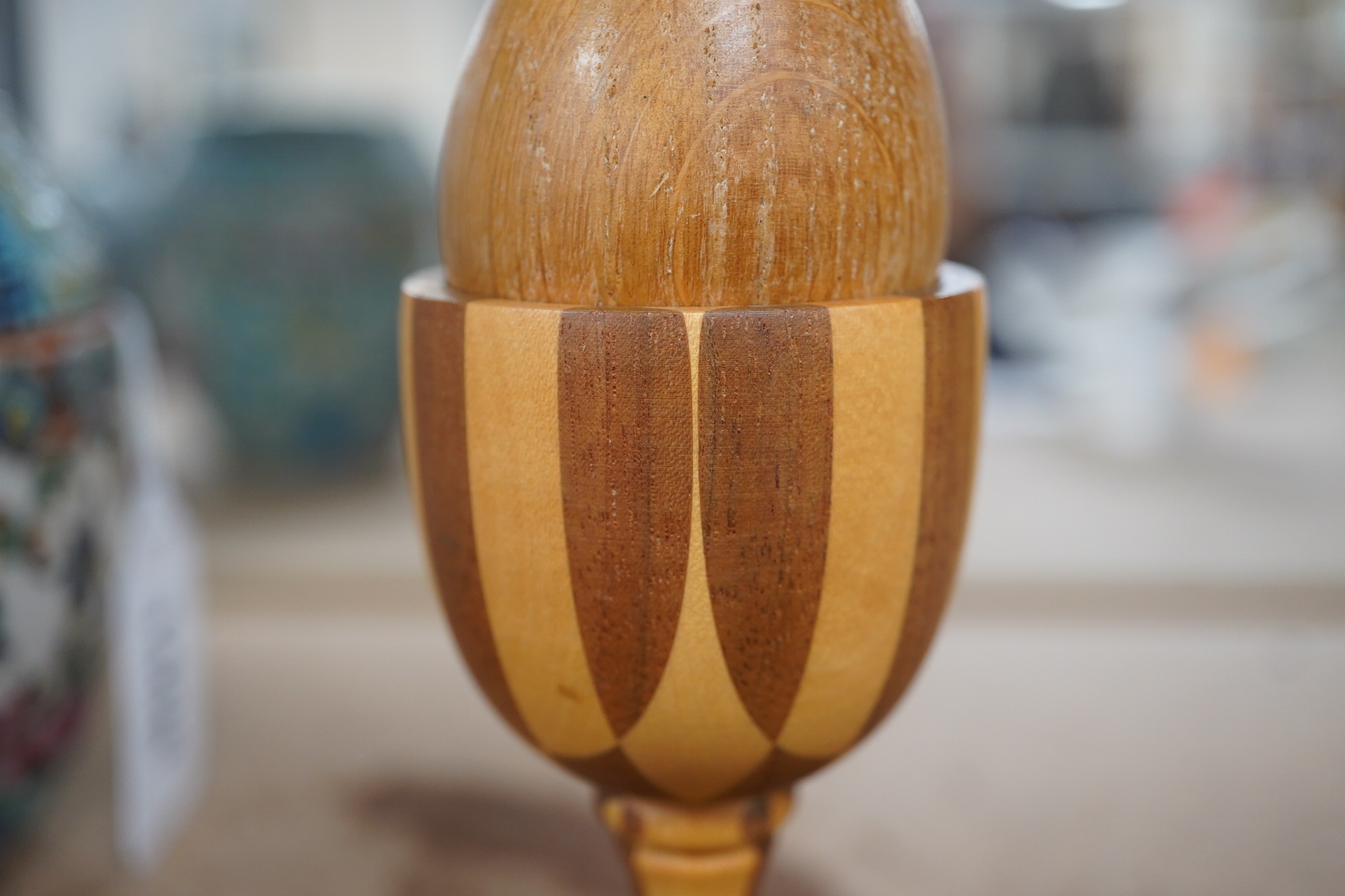 A Linley apple and holly wood egg cup with an oak egg, overall 14cm high. Condition - good